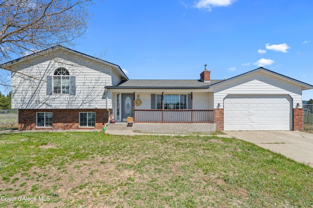 29 Silver Mountain Ln, Oldtown, ID 83822 - split level home with brick siding, a porch, driveway, an attached garage, and a chimney