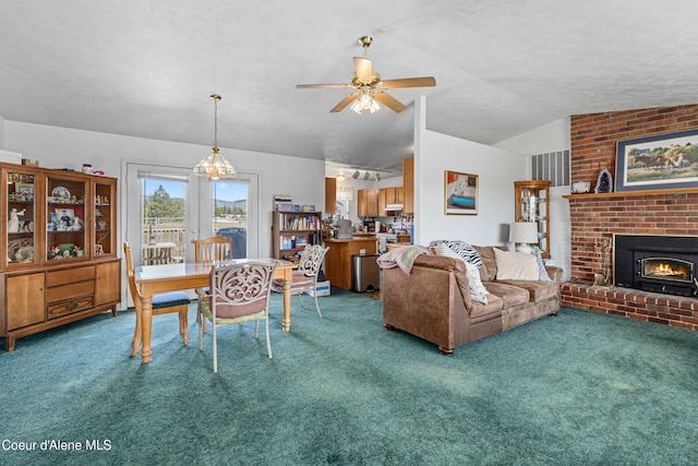 29 Silver Mountain Ln, Oldtown, ID 83822 - living area featuring carpet floors, ceiling fan, vaulted ceiling, a fireplace, and a textured ceiling