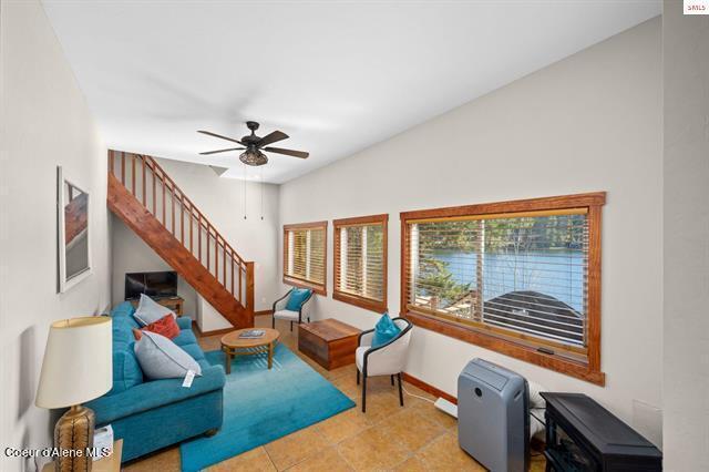 24010 N Bridge Lake Rd, Rathdrum, ID 83858 - living area with stairs, a ceiling fan, baseboards, and tile patterned flooring