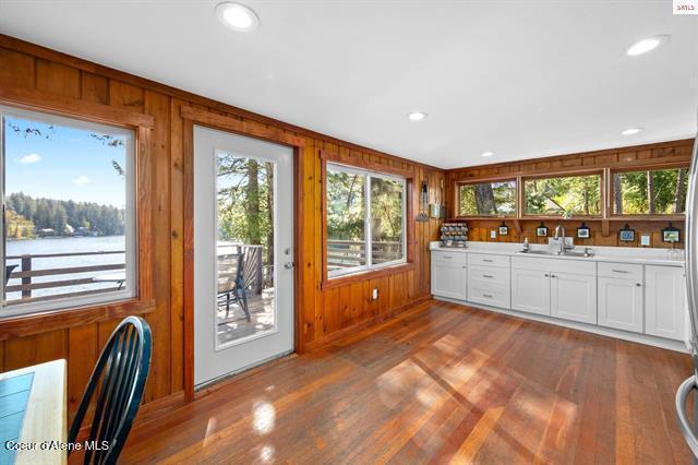 24010 N Bridge Lake Rd, Rathdrum, ID 83858 - bar with a sink, wood walls, dark wood-style floors, recessed lighting, and baseboards