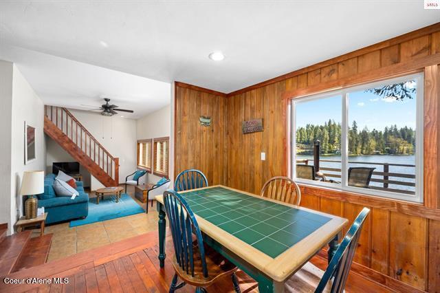 24010 N Bridge Lake Rd, Rathdrum, ID 83858 - dining area featuring stairway, wooden walls, hardwood / wood-style floors, ceiling fan, and recessed lighting