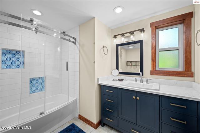 24010 N Bridge Lake Rd, Rathdrum, ID 83858 - full bathroom with vanity, baseboards, combined bath / shower with glass door, tile patterned flooring, and recessed lighting