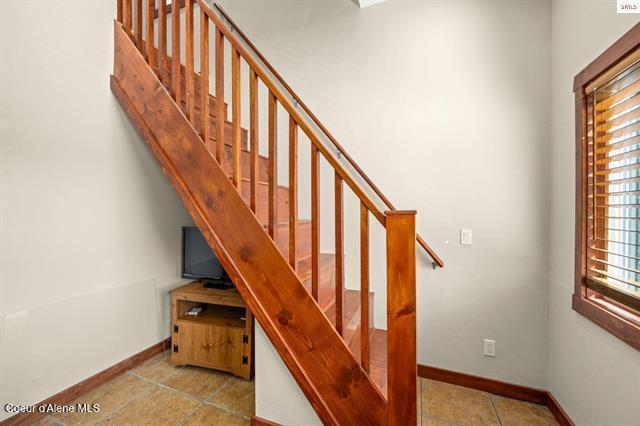 24010 N Bridge Lake Rd, Rathdrum, ID 83858 - stairs featuring baseboards and tile patterned flooring