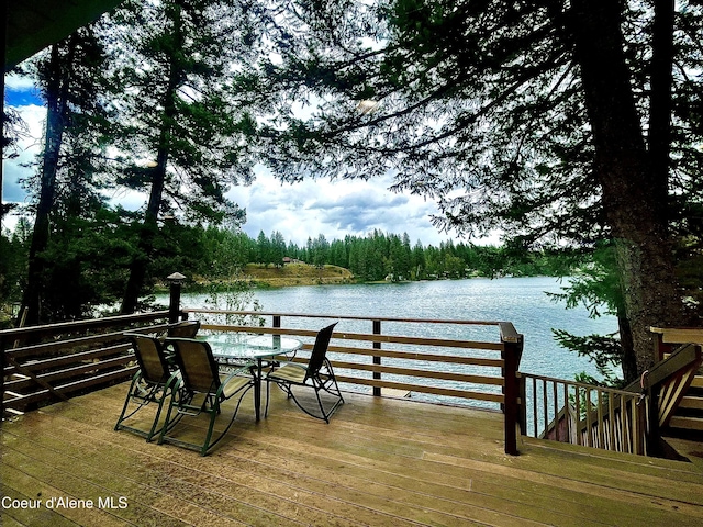 24010 N Bridge Lake Rd, Rathdrum, ID 83858 - deck featuring a water view, outdoor dining area, and a forest view