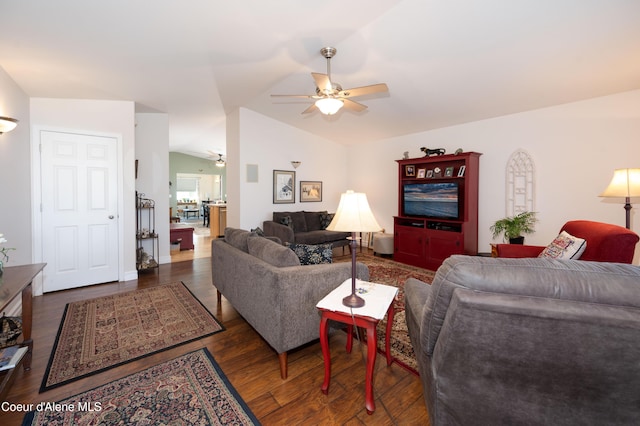 living room with a ceiling fan, wood finished floors, lofted ceiling, and baseboards