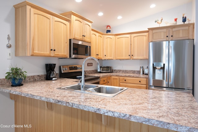 kitchen with appliances with stainless steel finishes, light brown cabinetry, light countertops, recessed lighting, and a peninsula