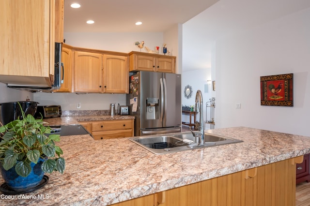 kitchen with stainless steel fridge with ice dispenser, a sink, light countertops, and recessed lighting