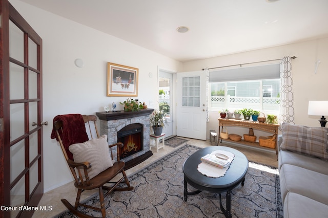 living area with a fireplace and french doors