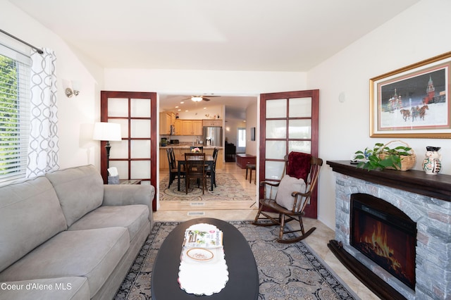 living area featuring a stone fireplace