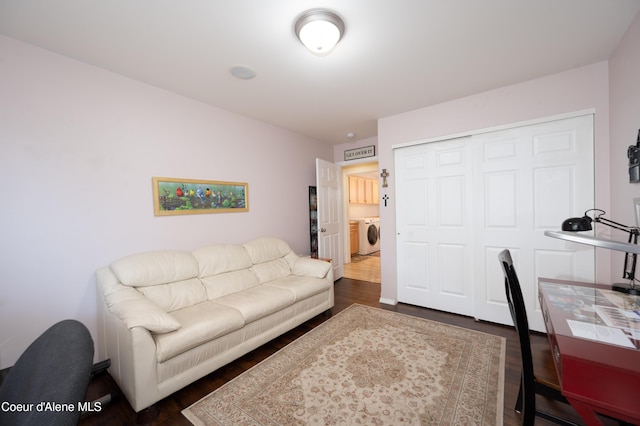 office with washing machine and dryer and dark wood-style flooring