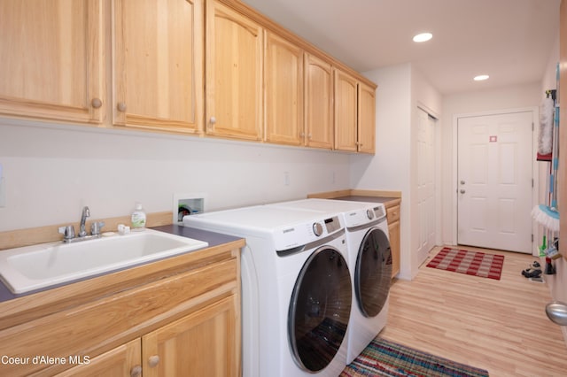 laundry area with cabinet space, separate washer and dryer, light wood finished floors, and recessed lighting