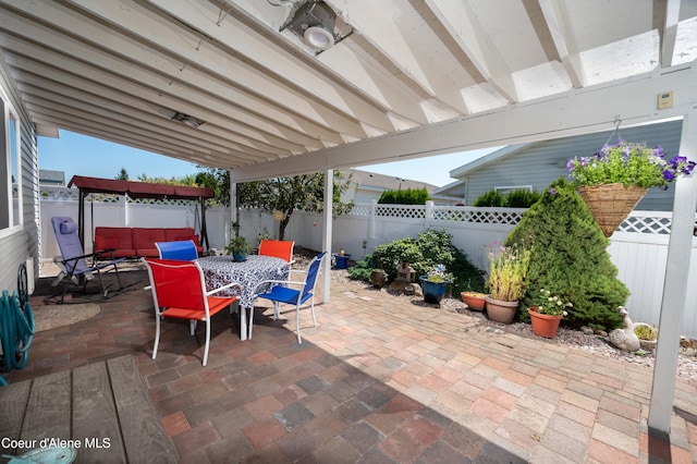 view of patio with outdoor dining area and a fenced backyard