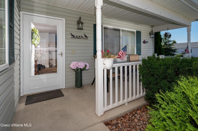 view of exterior entry with a porch
