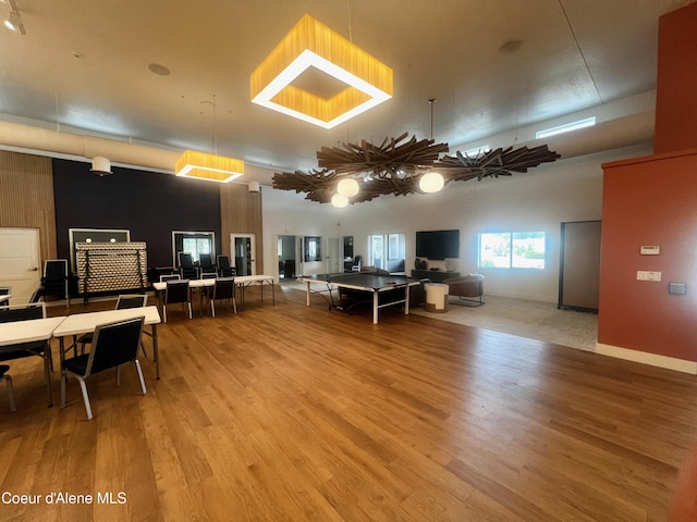 living room featuring wood finished floors and a towering ceiling