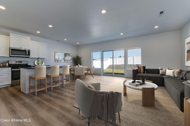 717 N Creative Way, Post Falls, ID 83854 - living room with dark wood finished floors and recessed lighting