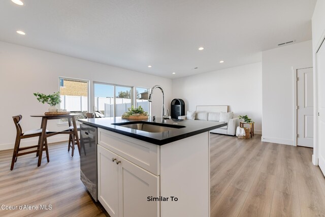 717 N Creative Way, Post Falls, ID 83854 - kitchen with a sink, dishwasher, dark countertops, light wood-style flooring, and white cabinets