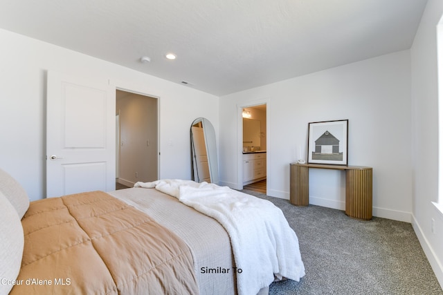 717 N Creative Way, Post Falls, ID 83854 - carpeted bedroom with baseboards, recessed lighting, and ensuite bathroom