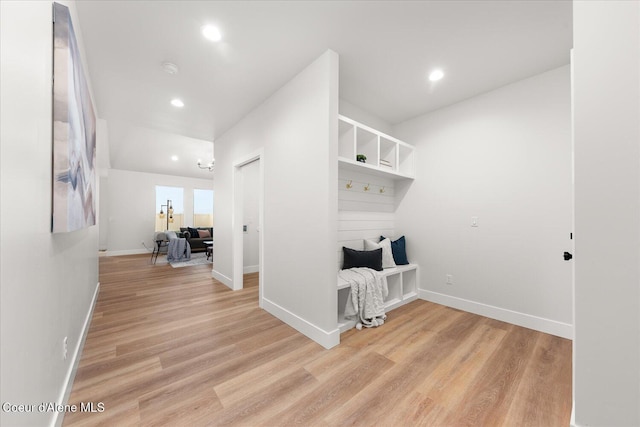clothes washing area featuring light wood finished floors, recessed lighting, and baseboards