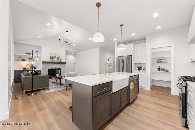 kitchen featuring stainless steel appliances, white cabinets, built in features, light countertops, and recessed lighting