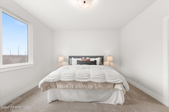 carpeted bedroom featuring baseboards