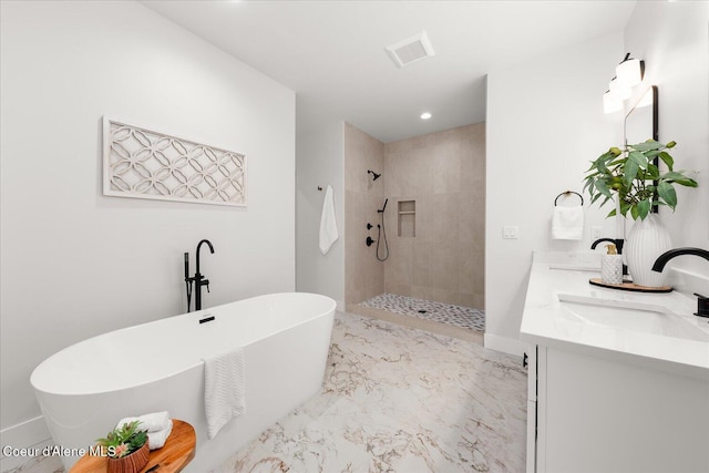 bathroom featuring a tile shower, a soaking tub, double vanity, marble finish flooring, and baseboards