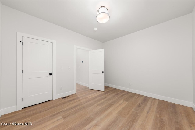 unfurnished bedroom featuring baseboards and light wood-style floors