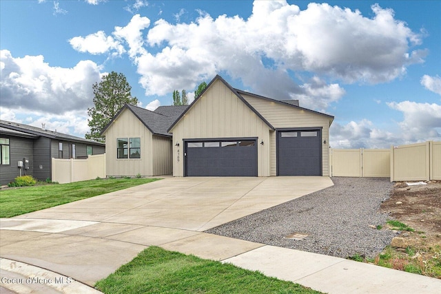 view of front of house featuring concrete driveway, a garage, board and batten siding, and a gate
