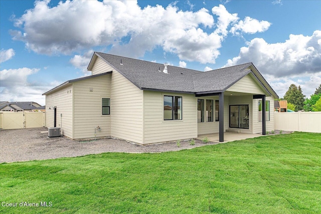 rear view of house with a patio, central AC unit, roof with shingles, and a gate