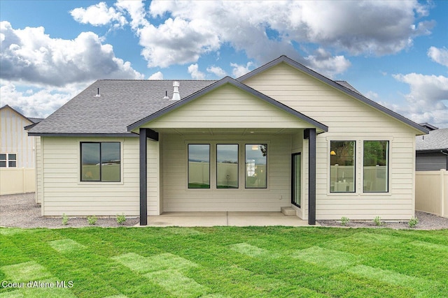 back of house featuring a patio area and roof with shingles