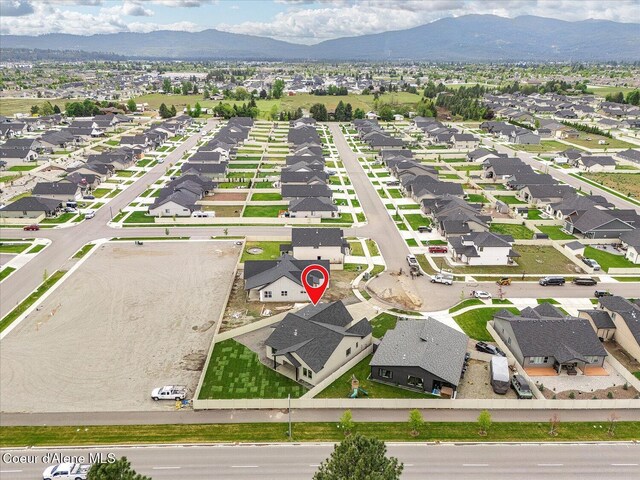 view of property location with a mountain backdrop and nearby suburban area