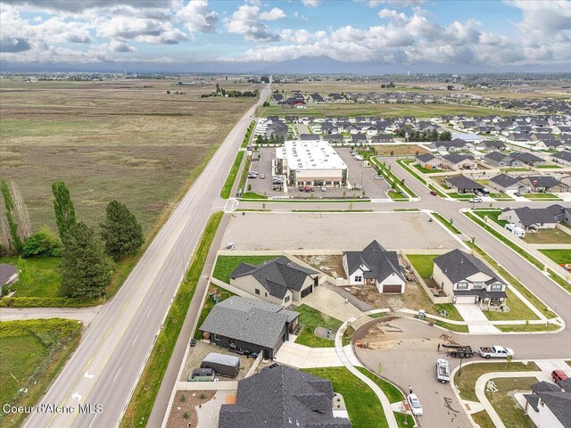 aerial view of property and surrounding area featuring nearby suburban area