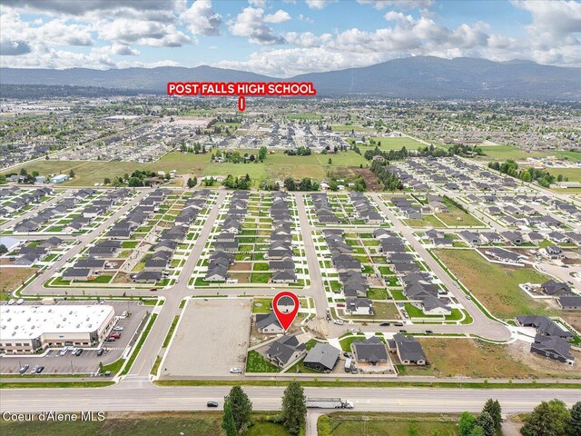 aerial view of property's location with a mountain backdrop and nearby suburban area