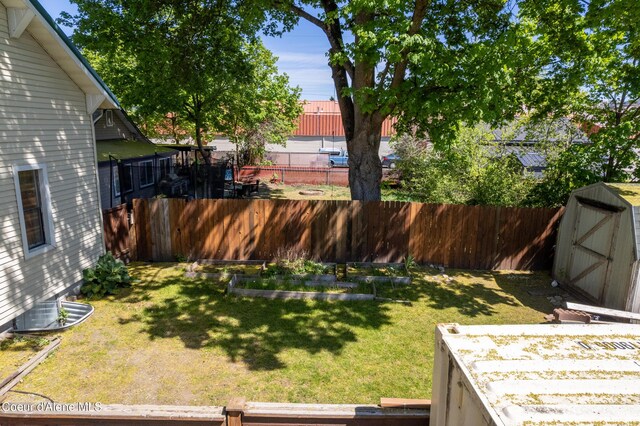 610 W Emma Ave, Coeur Dalene, ID 83814 - view of yard with a storage shed, a vegetable garden, and an outbuilding
