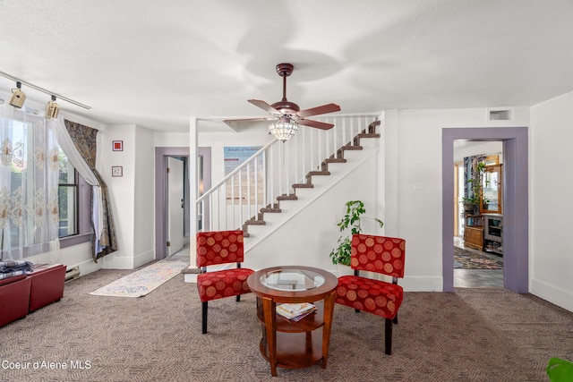 610 W Emma Ave, Coeur Dalene, ID 83814 - living area with carpet flooring, stairway, a ceiling fan, and baseboards