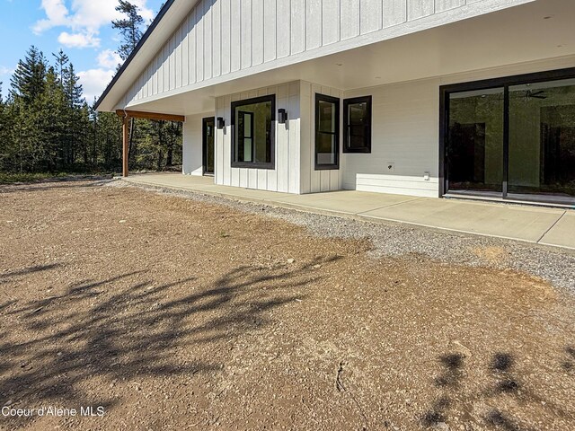 624 Satchel Dr, Spirit Lake, ID 83869 - rear view of house featuring a patio area and board and batten siding