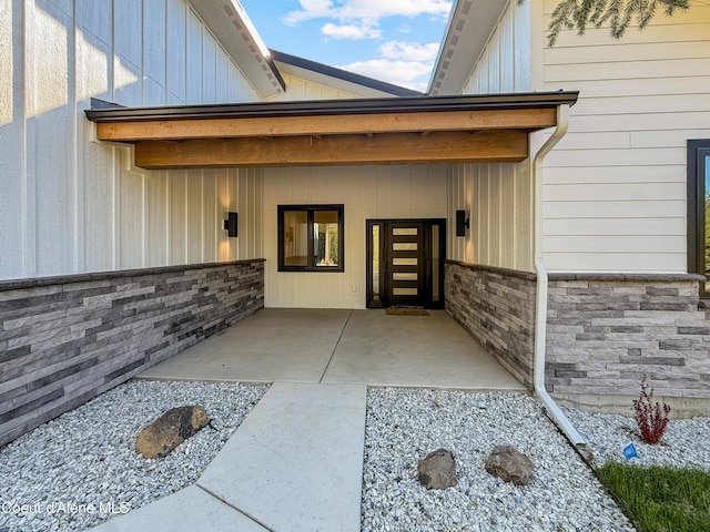 624 Satchel Dr, Spirit Lake, ID 83869 - doorway to property featuring board and batten siding