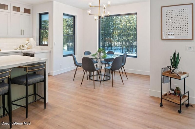 624 Satchel Dr, Spirit Lake, ID 83869 - dining area featuring a chandelier, light wood-style floors, plenty of natural light, and baseboards
