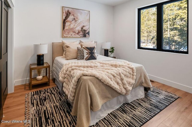 624 Satchel Dr, Spirit Lake, ID 83869 - bedroom featuring baseboards and light wood-style flooring