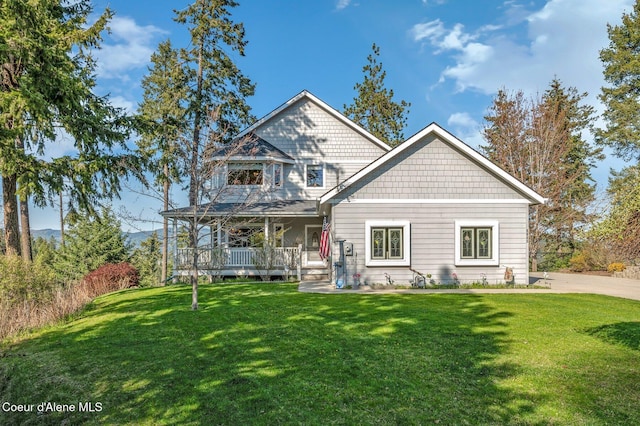 9798 N Willowherb Ct, Hauser, ID 83854 - view of front of home featuring a porch and a front lawn