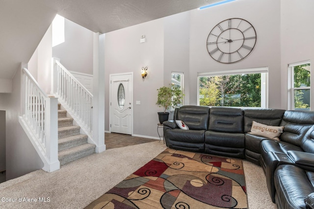 9798 N Willowherb Ct, Hauser, ID 83854 - living area with a towering ceiling, stairs, and baseboards