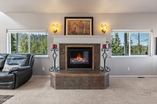 9798 N Willowherb Ct, Hauser, ID 83854 - living room with carpet floors, a tile fireplace, and baseboards