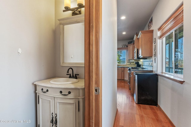 9798 N Willowherb Ct, Hauser, ID 83854 - kitchen with a sink, light wood-style floors, gas range oven, and recessed lighting