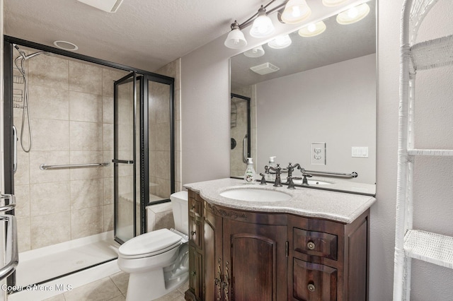 9798 N Willowherb Ct, Hauser, ID 83854 - bathroom featuring a shower stall, toilet, tile patterned floors, and vanity