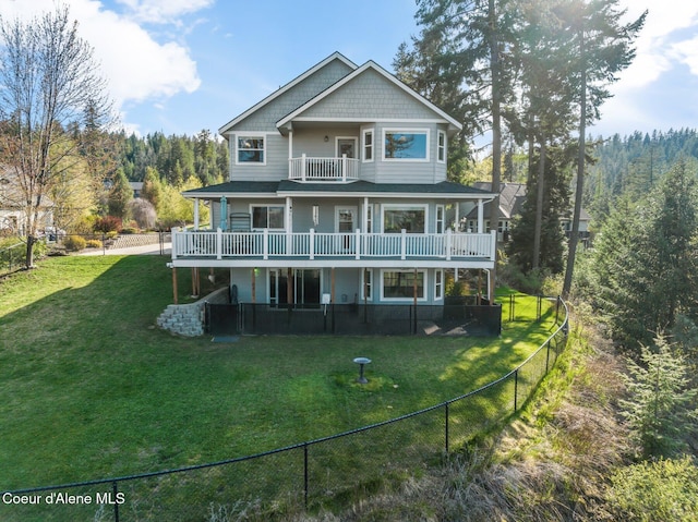9798 N Willowherb Ct, Hauser, ID 83854 - back of house featuring a deck, a balcony, and a view of trees