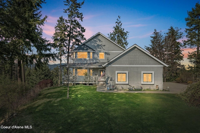 9798 N Willowherb Ct, Hauser, ID 83854 - rear view of property featuring covered porch and a yard