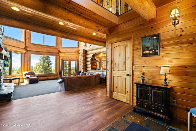1050 Greenview Ln, Moscow, ID 83843 - living room featuring rustic walls, a high ceiling, recessed lighting, and dark wood-style floors