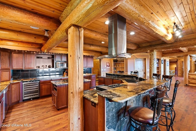 1050 Greenview Ln, Moscow, ID 83843 - kitchen featuring beverage cooler, appliances with stainless steel finishes, island exhaust hood, light wood-type flooring, and wooden ceiling