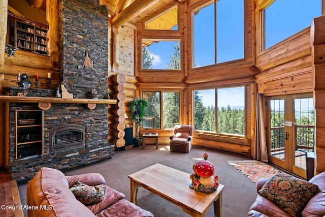 1050 Greenview Ln, Moscow, ID 83843 - carpeted living room with a high ceiling, log walls, french doors, and a fireplace