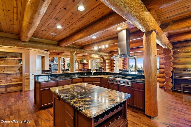 1050 Greenview Ln, Moscow, ID 83843 - kitchen with island exhaust hood, log walls, recessed lighting, stainless steel gas cooktop, and dark wood-type flooring