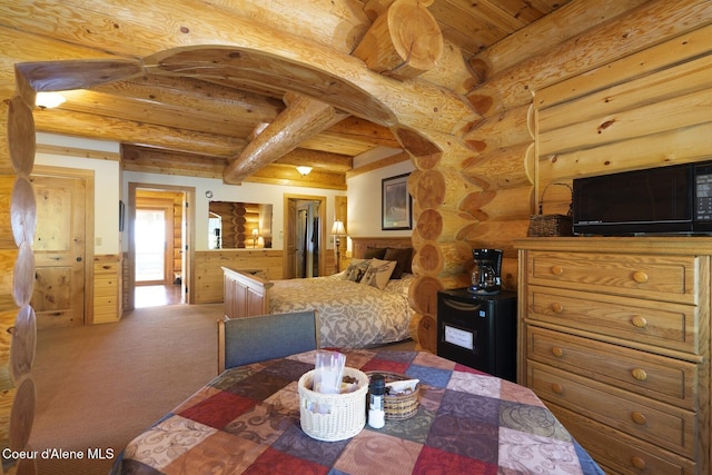 1050 Greenview Ln, Moscow, ID 83843 - bedroom featuring wooden ceiling, beamed ceiling, fridge, log walls, and carpet